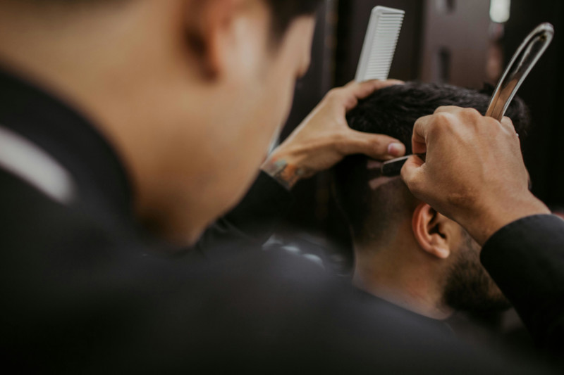 Barbeiro cortando o cabelo do cliente